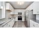 Modern kitchen with white cabinets and granite countertops at 15700 E Jamison Dr # 8-203, Englewood, CO 80112