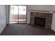 Living room with fireplace and sliding glass door to deck at 12043 W Cross Dr # 201, Littleton, CO 80127