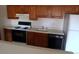 Kitchen with wood cabinets, stove and dishwasher at 12043 W Cross Dr # 201, Littleton, CO 80127