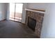 Living room with stone fireplace and access to patio at 12043 W Cross Dr # 201, Littleton, CO 80127