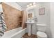 Clean bathroom with tile shower/tub and pedestal sink at 8224 E Kenyon Dr, Denver, CO 80237