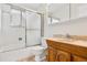 Bathroom with a tub, shower, and wood vanity at 1151 S Nome St, Aurora, CO 80012