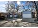Two-car garage and front yard view of a ranch-style home with mature trees at 1151 S Nome St, Aurora, CO 80012