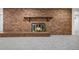 Brick fireplace with a wood mantel in the basement at 1151 S Nome St, Aurora, CO 80012