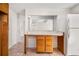 Kitchen features oak cabinets, tile countertops, and a pass-through window at 1151 S Nome St, Aurora, CO 80012