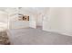 Spacious living room featuring neutral carpeting and a view into the kitchen at 1151 S Nome St, Aurora, CO 80012