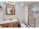 Basement bathroom with shower and wood vanity at 18872 E Prentice Pl, Centennial, CO 80015