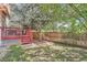 Landscaped backyard with wooden fence and large tree at 18872 E Prentice Pl, Centennial, CO 80015