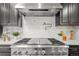 Stainless steel range with modern backsplash in a contemporary kitchen setting at 1810 Winfield Dr, Lakewood, CO 80215