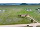 Aerial view showing a house, garage, and surrounding land on a rural road at 12155 Mesa View Rd, Larkspur, CO 80118