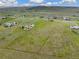 Aerial view of a rural landscape with houses and agricultural land at 12155 Mesa View Rd, Larkspur, CO 80118