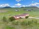 Aerial view of a ranch-style home with detached garage and expansive land at 12155 Mesa View Rd, Larkspur, CO 80118
