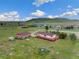 Aerial view of a home with a large yard, outbuildings, and distant mountains at 12155 Mesa View Rd, Larkspur, CO 80118