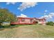 Exterior view of a ranch home with a large deck overlooking a grassy yard at 12155 Mesa View Rd, Larkspur, CO 80118