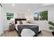 Bright bedroom with a queen bed, two nightstands, and large window at 4301 Bryant St, Denver, CO 80211