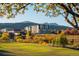 Residential building with mountain views and autumn foliage at 12983 W Ida Ave # 107 Ada Type A, Littleton, CO 80127