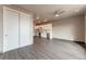 Open living room with kitchen access, wood-look floors, and ceiling fan at 12983 W Ida Ave # 107 Ada Type A, Littleton, CO 80127