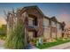 Two-story townhome with stone accents and landscaped grounds at 15195 E 16Th Pl # 204, Aurora, CO 80011