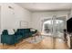 Living room with hardwood floors, comfy seating, and access to balcony at 15195 E 16Th Pl # 204, Aurora, CO 80011