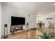 Entryway with hardwood floors, modern media console, and view to dining area at 15195 E 16Th Pl # 204, Aurora, CO 80011