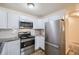 Modern kitchen with white cabinets, granite countertops, and stainless steel appliances at 735 S Alton Way # 3A, Denver, CO 80247