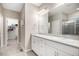 Double vanity bathroom with granite countertop and a walk-in shower at 1170 Mcmurdo Cir, Castle Rock, CO 80108