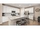 Modern kitchen with white cabinets and granite counters at 1170 Mcmurdo Cir, Castle Rock, CO 80108