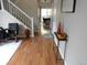 Bright hallway with hardwood floors leading to the living areas at 19583 E Hollow Creek Dr, Parker, CO 80134