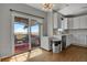 Kitchen with white cabinets, stainless steel appliances, and access to a patio at 3188 S County Road 137, Bennett, CO 80102