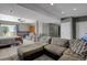 Finished basement with large sectional sofa and sliding glass door at 3188 S County Road 137, Bennett, CO 80102