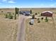 Aerial view of property; features a house, barn, and spacious grounds at 3188 S County Road 137, Bennett, CO 80102