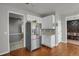 Bright kitchen with white cabinets, stainless steel appliances and hardwood floors at 3188 S County Road 137, Bennett, CO 80102
