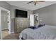 Bedroom with large TV, dresser, and ensuite bathroom access at 3188 S County Road 137, Bennett, CO 80102