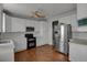 Modern kitchen with white cabinets, stainless steel appliances, and hardwood floors at 3188 S County Road 137, Bennett, CO 80102