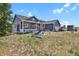 Blue house with red accents and porch swing at 3188 S County Road 137, Bennett, CO 80102