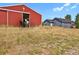 Red barn with horses and adjacent two story house at 3188 S County Road 137, Bennett, CO 80102