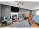 Spacious living room featuring a fireplace, large TV, and comfortable seating at 3188 S County Road 137, Bennett, CO 80102