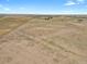 Aerial view of property showcasing a large lot and distant buildings at 3188 S County Road 137, Bennett, CO 80102
