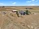 Aerial view of property featuring a house, barn, and open fields at 3188 S County Road 137, Bennett, CO 80102