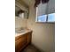 Clean bathroom with vanity, sink, and window at 11742 E Jewell Pl, Aurora, CO 80012