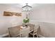 Dining area with a wood table, chairs, and modern light fixture at 1465 S Depew St, Lakewood, CO 80232