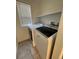 Bright laundry room with washer and dryer, and tile floor at 6043 S Waco St, Aurora, CO 80016