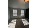 Spacious bedroom with two windows and neutral walls at 6043 S Waco St, Aurora, CO 80016
