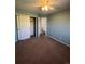 Bedroom with double doors to closet and carpet at 6043 S Waco St, Aurora, CO 80016