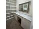 Large walk-in closet with built-in shelving and vanity at 6043 S Waco St, Aurora, CO 80016
