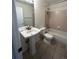 Bathroom with tub, toilet and pedestal sink at 6043 S Waco St, Aurora, CO 80016