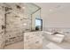 Spacious modern bathroom with a walk-in shower, soaking tub, and stylish tile at 3534 Running Deer Dr, Castle Rock, CO 80109