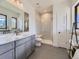 Modern bathroom with gray vanity, marble countertop, and walk-in shower at 3534 Running Deer Dr, Castle Rock, CO 80109