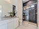 Modern bathroom with herringbone tile shower, white vanity, and updated fixtures at 3534 Running Deer Dr, Castle Rock, CO 80109