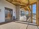 Covered porch with stone accents and a wooden deck, offering views of the neighborhood at 3534 Running Deer Dr, Castle Rock, CO 80109